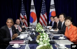 U.S. President Barack Obama, left, and South Korean President Park Geun-hye, right, look to the media at the conclusion of a bilateral meeting in Vientiane, Laos, Sept. 6, 2016.