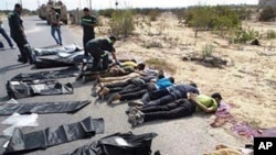 The bodies of Egyptian policemen who were killed near the border town of Rafah, North Sinai, Egypt, lie on the ground Monday, Aug. 19, 2013.