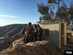 Iraqi Kurdish Peshmerga soldiers huddle around Maj. Gen. Sirwan Barzani in Makhmour, Iraq. Makhmour is expected to serve as one of the staging points for Iraqi and Peshmerga forces in the advance against the Islamic State-controlled city of Mosul.