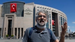 FILE - Erol Onderoglu, a journalist and Reporters Without Borders Turkey representative, talks outside a court in Istanbul, Turkey, July 16, 2020.