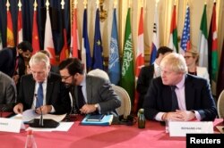 FILE - Britain's Foreign Secretary Boris Johnson (R) and French Foreign Minister Jean-Marc Ayrault (L) attend a ministerial summit to hold discussion on the future of Mosul city, post-Islamic State, in Paris, France, Oct. 20, 2016.