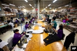 Workers manufacture car dash mats at a maquiladora belonging to the TECMA group in Ciudad Juarez, Mexico, Dec. 27, 2013. With the implementation of NAFTA, many North American and international companies moved manufacturing to Mexico at a lower cost.