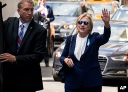FILE - U.S. Democratic presidential nominee Hillary Clinton waves to the press as she leaves her daughter's apartment building after resting on Sept. 11, 2016, in New York.