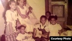 Jessi Calzado-Esponda (center) is seen at home in Cuba before she left as an accidental refugee at the age of seven.