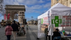 A man gets a nasal swap at a mobile COVID-19 testing site at the Champs Elysees avenue in Paris, Jan. 5, 2022.