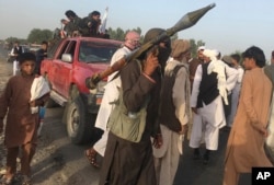 FILE - Taliban fighters gather in Surkhroad district of Nangarhar province, east of Kabul, Afghanistan.