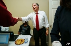 FILE - Democratic Alabama U.S. Senate candidate Doug Jones stops along the campaign trial to greet volunteers, in Montgomery, Alabama, Nov. 29, 2017.