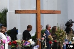 Mourners wait in line to attend the funeral of Cynthia Hurd, 54, at the Emanuel African Methodist Episcopal Church in Charleston, S.C., where she was killed June 17 along with eight others, June 27, 2015.