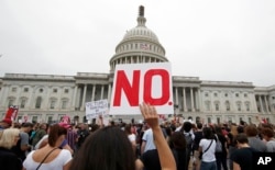 Activists demonstrate in the plaza of the East Front of the U.S. Capitol to protest the confirmation vote of Supreme Court nominee Brett Kavanaugh on Capitol Hill, Oct. 6, 2018, in Washington.