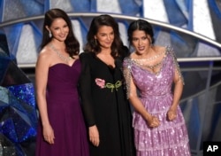 Ashley Judd, from left, Annabella Sciorra and Salma Hayek speak at the Oscars, March 4, 2018.