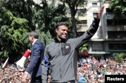 Venezuelan opposition leader Juan Guaido and fellow opposition leader Leopoldo Lopez address a crowd of supporters in Caracas, April 30, 2019.