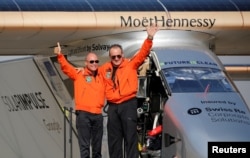 FILE - Andre Borschberg, right, the Swiss pilot of Solar Impulse 2, is greeted by fellow pilot and countryman Bertrand Piccard after landing at Cairo Airport, Egypt, July 13, 2016.