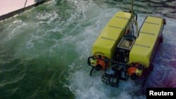 FILE - A Deep Drone underwater surveyor is lowered from the United States Navy's USS Grapple during a "wet check".
