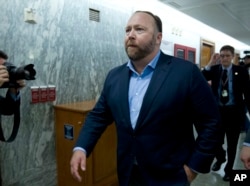 FILE - Conspiracy theorist Alex Jones is pictured on Capitol Hill in Washington after he listened to testimony to lawmakers, Sept. 5, 2018. On Oct. 23, 2018, Twitter confirmed it had removed accounts linked to Jones and the Infowars website.