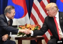 US President Donald Trump (R) looks on as South Korean President Moon Jae-in speaks during a bilateral meeting in New York on September 24, 2018, a day before the start of the General Debate of the 73rd session of the General Assembly. / AFP PHOTO.