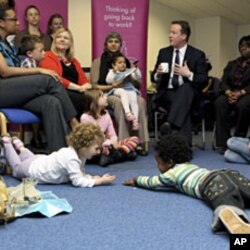 One month before becoming prime minister, Britain's Conservative Party leader David Cameron David Cameron (C) visits the Women Like Us agency in London, which supports mothers looking for flexible work and businesses seeking part-time staff, April 14, 201