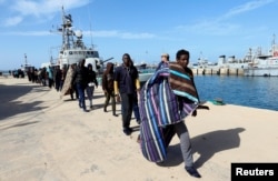 Migrants arrive at a naval base after they were rescued by the Libyan coast guard in Tripoli, Libya, March 13, 2018.
