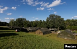 FILE - Tents are erected by the Canadian Armed Forces to house asylum seekers at the Canada-U.S. border in Lacolle, Quebec, Aug. 9, 2017.