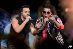 FILE - Singers Luis Fonsi, left and Daddy Yankee perform during the Latin Billboard Awards in Coral Gables, Fla., April 27, 2017. Malaysia has banned their hit song "Despacito" on state radio and television. The ban applies only to government-run radio an