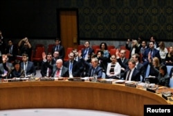 FILE - Members of the U.N. Security Council vote for cease-fire to Syrian bombing in eastern Ghouta, at U.N. headquarters in New York, Feb. 24, 2018.
