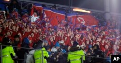 North Korean cheerleaders wave flags before the opening ceremony of the 2018 Winter Olympics in Pyeongchang, South Korea, Friday, Feb. 9, 2018.