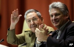 President Raul Castro waves during a twice-annual legislative session at the National Assembly in Havana, Dec. 19, 2014.