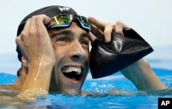 United States' Michael Phelps reacts after the men's 100-meter butterfly final during the swimming competitions at the 2016 Summer Olympics, Friday, Aug. 12, 2016, in Rio de Janeiro, Brazil.