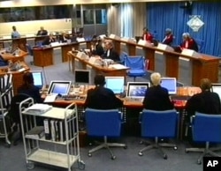 FILE - In this Tuesday Sept. 7, 2004, image made from TV, Slobodan Milosevic, second from top left, appears before the International Criminal Tribunal for the former Yugoslavia in The Hague, Netherlands.