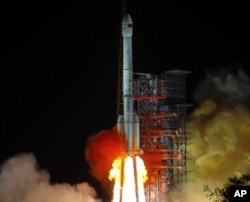 FILE - In this Dec. 8, 2018, file photo, and released by Xinhua News Agency, the Chang'e 4 lunar probe launches from the the Xichang Satellite Launch Center in southwestern China's Sichuan province. (Jiang Hongjing/Xinhua via AP, File)