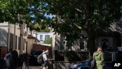 Members of the media gather on Sept. 19, 2020, in front of the childhood home of Justice Ruth Bader Ginsburg in the Brooklyn borough of New York.