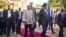 South Sudan's rebel leader and now Vice President Riek Machar, center left, walks with President Salva Kiir after being sworn in at the presidential palace in the capital Juba, South Sudan, April 26, 2016.