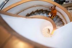 FILE - A Thai Buddhist monk talks on a mobile phone during a visit to Bangkok Art and Culture Center, Thailand, Sept. 17, 2019.