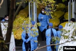 A staff member walks next to several body bags at a funeral home, as coronavirus disease (COVID-19) outbreaks continue in Shanghai, China on January 4, 2023. (REUTERS/Staff)