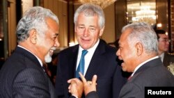East Timor PM Xanana Gusmao (L-R) mingles with Indonesia's Defence Minister Purnomo Yusgiantoro and U.S. Defense Secretary Chuck Hagel before the keynote address of the 12th International Institute for Strategic Studies (IISS) Asia Security Summit: The Sh