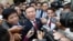 FILE - Cambodia's main opposition Cambodia National Rescue Party Deputy President Kem Sokha, center, speaks to reporters outside the Phnom Penh Municipality Court in Phnom Penh, Cambodia, April 8, 2015. 