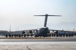 FILE - U.S. soldiers arrive to provide security for evacuees, at Hamid Karzai International Airport in Kabul, Afghanistan, Aug. 20, 2021.