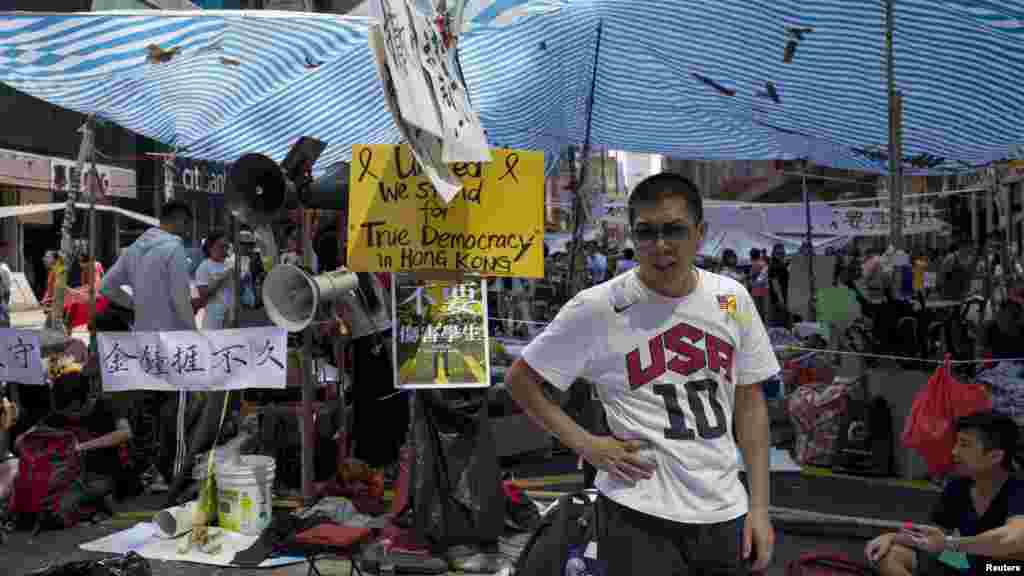An Occupy Central movement protester stands guard on a main road at the Mong Kok shopping district in Hong Kong, Oct. 6, 2014. 