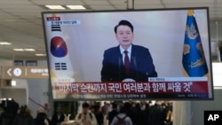 A TV screen at a bus terminal in Seoul shows South Korean President Yoon Suk Yeol's televised briefing, Dec. 12, 2024.