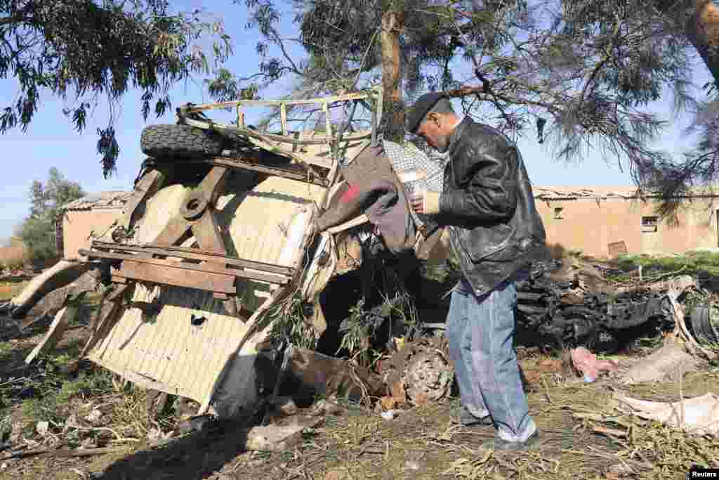 A man looks at the scene near a military base 50 km outside Benghazi, after a suicide bomber detonated a truck packed with explosives at an army checkpoint, Barsis, Libya, Dec. 22, 2013.&nbsp;