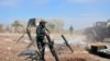 FILE - In this photo released by the Syrian official news agency SANA, Syrian army soldiers prepare to launch a mortar toward insurgents in the village of Kfar Nabuda, in the countryside of Hama province, Syria, May 11, 2019.