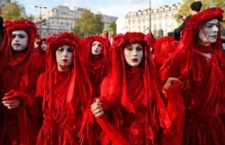 FILE - Protesters from the group Extinction Rebellion walk to Hyde Park in London, April 25, 2019.