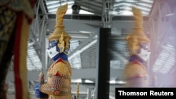 A Thai traditional giant statue wears a protective mask, amid the coronavirus disease (COVID-19) pandemic, at Suvarnabhumi Airport in Bangkok, Thailand, Dec. 15, 2020.