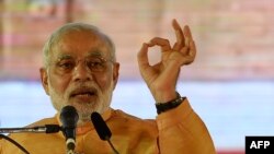 Indian Prime Minister and Bharatiya Janata Party leader Narendra Modi gestures as he speaks during a public rally ahead of the Maharashtra state election, Mumbai, Oct. 4, 2014.