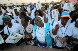 Women sing as they await the arrival of Pope Francis in Maputo, Mozambique, Sept. 4, 2019.