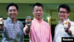 Huawei's Singapore CEO Zhou Bin (L-R), David Wei, President of Huawei South Pacific and Lim Chee Siong Chief Marketing Officer, Huawei South Pacific, show the new Huawei Ascend P6 Android-based smartphones during their launch at CommunicAsia communication