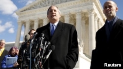 FILE - Texas Attorney General Ken Paxton addresses reporters on the steps of the U.S. Supreme Court in Washington, March 2, 2016. 