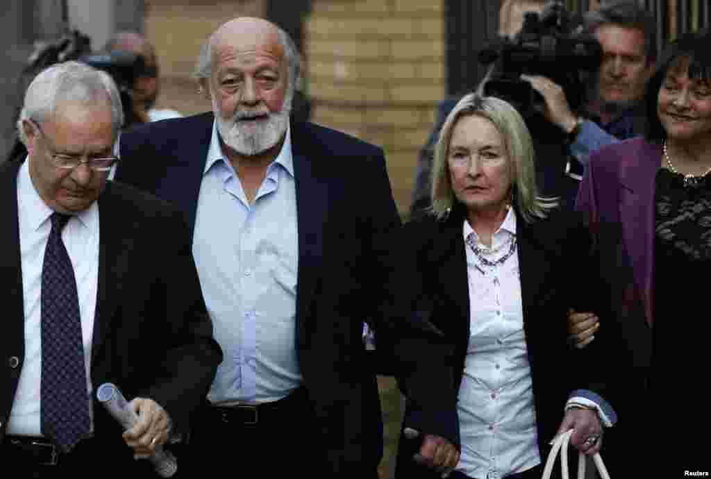 Reeva Steenkamp's parents, June (second from right) and Barry Steenkamp (second from left), arrive for the closing arguments in Oscar Pistorius' murder trial, at the high court in Pretoria, Aug. 7, 2014.