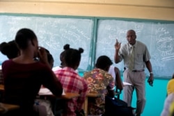 Students listen to school Director Jean Marc Charles at the Lycée school, which reopened about a week earlier than other schools in Petion-Ville, Haiti, Nov. 28, 2019.