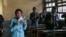 Students drink from bottles of Covid Organics, a herbal tea touted by Madagascar President Andry Rajoelina as a powerful remedy against COVID-19, at a high school in Antananarivo, April 23, 2020.