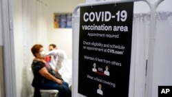 A patient receives a shot of the Moderna COVID-19 vaccine at a CVS Pharmacy branch in Los Angeles, March 1, 2021.